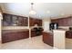 Kitchen with dark cabinets and modern appliances at 563 Copperdale Ave, Winter Garden, FL 34787