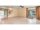 Open-concept living area features tile flooring, staircase and large glass sliding door to backyard at 563 Copperdale Ave, Winter Garden, FL 34787