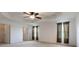 Spacious main bedroom featuring a tray ceiling, ceiling fan, neutral carpet, and bright natural light at 563 Copperdale Ave, Winter Garden, FL 34787