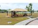 Community playground area with shade and seating, perfect for outdoor activities in a Gathering-friendly neighborhood at 563 Copperdale Ave, Winter Garden, FL 34787