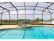 Enjoy this beautiful in-ground pool inside a screened enclosure with an adjoining spa and a neighborhood view at 563 Copperdale Ave, Winter Garden, FL 34787