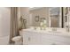 Elegant bathroom featuring double sinks, white cabinets, and a tub with a shower; enhanced by natural light at 5646 Ficus Aurea St, Kissimmee, FL 34758