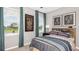 Inviting bedroom with vibrant artwork, stylish bedding, and large windows offering outdoor views at 5646 Ficus Aurea St, Kissimmee, FL 34758