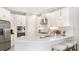 Modern kitchen with white cabinetry, stainless steel appliances, and a spacious island at 5646 Ficus Aurea St, Kissimmee, FL 34758