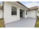 Covered back porch with a sliding door and plenty of room for outdoor seating at 7602 Glenmoor Ln, Winter Park, FL 32792