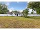 Spacious backyard with a fence and mature trees providing shade at 7602 Glenmoor Ln, Winter Park, FL 32792