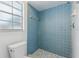 Bathroom features blue tile shower with matching tile floor at 7602 Glenmoor Ln, Winter Park, FL 32792