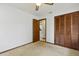 Bedroom with a ceiling fan and closet with a view of the tile floor in the hallway at 7602 Glenmoor Ln, Winter Park, FL 32792