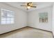 Bedroom featuring a ceiling fan and two windows with natural light at 7602 Glenmoor Ln, Winter Park, FL 32792