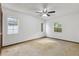 Cozy bedroom with carpet, ceiling fan, and natural light streaming through the windows at 7602 Glenmoor Ln, Winter Park, FL 32792