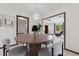 Dining room featuring a modern chandelier and views to the outdoor scenery and living room at 7602 Glenmoor Ln, Winter Park, FL 32792