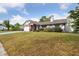 View of single Gathering home showcasing brick accents, a manicured lawn, and a two-car garage at 7602 Glenmoor Ln, Winter Park, FL 32792