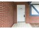 Close up of front door with number 7602, showcasing the brick exterior and white tiled entry at 7602 Glenmoor Ln, Winter Park, FL 32792