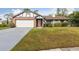 Charming single Gathering home showcasing brick accents, a well manicured lawn and a two car garage at 7602 Glenmoor Ln, Winter Park, FL 32792