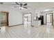 Bright kitchen area featuring white cabinets, black appliances, tile floors, and access to the living room at 7602 Glenmoor Ln, Winter Park, FL 32792