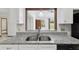 Kitchen featuring a stainless steel dual sink, granite countertop, and white cabinets at 7602 Glenmoor Ln, Winter Park, FL 32792