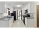 Bright kitchen features white cabinets, black appliances, and tiled floors, creating a clean and functional space at 7602 Glenmoor Ln, Winter Park, FL 32792