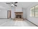 Inviting living room featuring a brick fireplace, ceiling fan, and seamless room transitions at 7602 Glenmoor Ln, Winter Park, FL 32792
