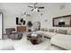 Bright, neutral living room featuring white tile floors, modern furniture, and an open view to the kitchen at 7602 Glenmoor Ln, Winter Park, FL 32792