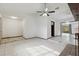 Spacious living area with fireplace, ceiling fan, transitions to multiple rooms, and natural light at 7602 Glenmoor Ln, Winter Park, FL 32792