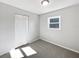Cozy bedroom featuring neutral carpet, a closet, and a window bringing in natural light at 800 Marion Dr, Mount Dora, FL 32757
