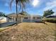 Charming single-story home with a front yard, carport, and inviting curb appeal on a sunny day at 800 Marion Dr, Mount Dora, FL 32757