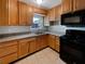 Functional kitchen with classic wooden cabinets, granite countertops, and modern appliances at 800 Marion Dr, Mount Dora, FL 32757