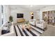 Bright, staged living room with sleek furniture, a modern rug, and an open concept design at 800 Marion Dr, Mount Dora, FL 32757