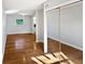 Open-concept space featuring hardwood floors leading to another room with a mirrored closet at 800 Marion Dr, Mount Dora, FL 32757