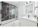Modern bathroom with a shower over bath, vanity sink and a mirrored cabinet at 8143 Britt Dr, Orlando, FL 32822