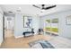 Bright bedroom with hardwood floors, a view of the backyard, and modern decor at 8143 Britt Dr, Orlando, FL 32822