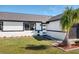 Beautiful home with manicured lawn, freshly painted exterior with black accents and a stylish front door at 8143 Britt Dr, Orlando, FL 32822