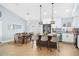 Kitchen and dining area featuring a center island with bar seating and pendant lights, open to the dining area at 8143 Britt Dr, Orlando, FL 32822
