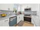 Bright kitchen featuring white cabinets, granite countertops, and stainless steel appliances at 8143 Britt Dr, Orlando, FL 32822