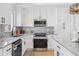 Modern kitchen featuring white cabinets, stainless steel appliances, and granite countertops at 8143 Britt Dr, Orlando, FL 32822