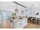 Bright open-concept kitchen and living room with a dining area, vaulted ceiling and modern decor at 8143 Britt Dr, Orlando, FL 32822