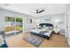 Main bedroom with a blue bed, rug and access to the yard through a glass sliding door at 8143 Britt Dr, Orlando, FL 32822
