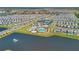 Aerial view of the community showcasing a pool, tennis courts, clubhouse, and lake with a fountain at 13231 Panama Beach Ct, Orlando, FL 32827