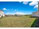 Spacious backyard featuring green grass, lush landscaping, and a picturesque water view at 13231 Panama Beach Ct, Orlando, FL 32827