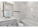 Bright bathroom featuring a white vanity and a shower-tub combo with elegant marble-style tiling at 13231 Panama Beach Ct, Orlando, FL 32827
