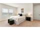 Bright bedroom boasts a comfortable bed, two ottomans and two windows overlooking the lake in the neighborhood at 13231 Panama Beach Ct, Orlando, FL 32827