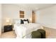 Bright bedroom boasts a comfortable bed, two ottomans and two windows overlooking the lake in the neighborhood at 13231 Panama Beach Ct, Orlando, FL 32827