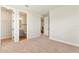 Bedroom features neutral colored carpet with two open doorways to a bathroom and hallway at 13231 Panama Beach Ct, Orlando, FL 32827