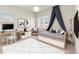 Stylishly decorated bedroom showcasing a modern bed, desk, and windows for a bright and inviting space at 13231 Panama Beach Ct, Orlando, FL 32827