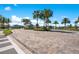 Inviting community entrance featuring manicured landscaping and a charming welcome center surrounded by palm trees at 13231 Panama Beach Ct, Orlando, FL 32827