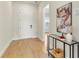 Bright entryway featuring wood-look tile flooring, modern decor, and a stylish console table at 13231 Panama Beach Ct, Orlando, FL 32827