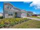 Attractive two-story home with a two-car garage, landscaped front yard, and modern architectural details at 13231 Panama Beach Ct, Orlando, FL 32827
