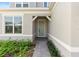 Inviting entryway with a modern front door, brick path, and lush landscaping providing curb appeal at 13231 Panama Beach Ct, Orlando, FL 32827