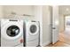 Convenient laundry room featuring modern, front-load washer and dryer and wire shelving at 13231 Panama Beach Ct, Orlando, FL 32827