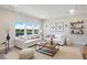 Bright living room featuring large windows with lake views, white sofas, and modern décor at 13231 Panama Beach Ct, Orlando, FL 32827